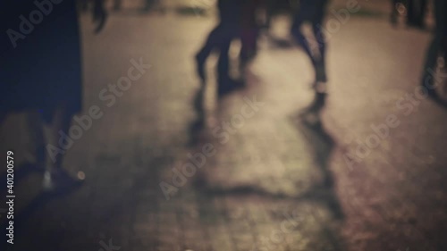 Salsa dancing in slow motion defocused. Couples silhouettes dance social dances outside in dark, shot with long shadows