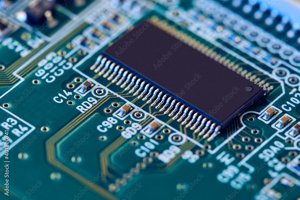 Electronic circuit board with electronic components such as chips close up. Blurry background. Electronic circuit board with electronic components such as chips close up. Blurry background.