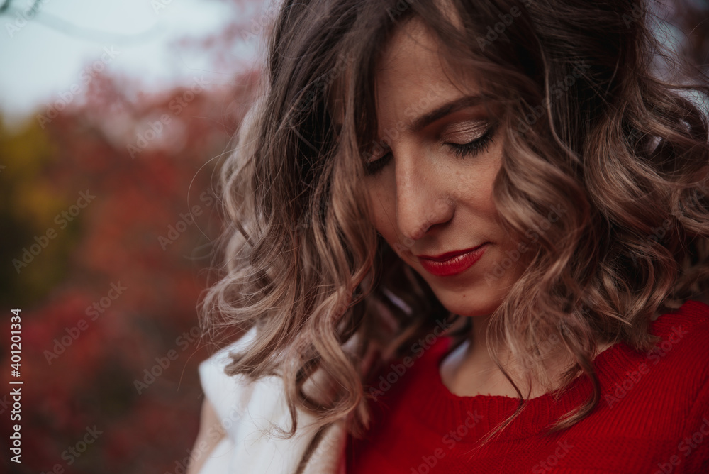 cute girl in an autumn park with a delicate beige scarf smiles. autumn. falling leaves cute girl in an autumn park with a delicate beige scarf smiles. autumn. falling leaves