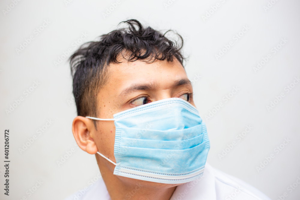 Portrait of young asian man wearing face protective medical mask for protection from virus disease Portrait of young asian man wearing face protective medical mask for protection from virus disease