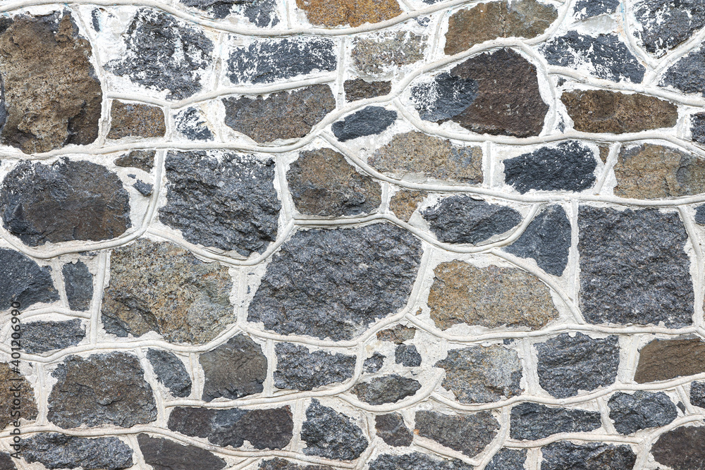 Background and texture of an old stone wall close up Background and texture of an old stone wall close up
