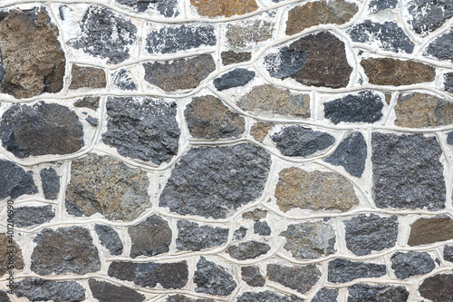 Background and texture of an old stone wall close up