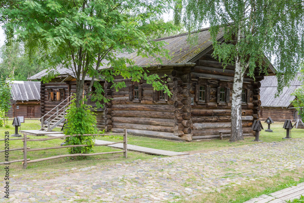 view of the old wooden houses in the park of Russian art in Kostroma, photo was taken on a cloudy summer day view of the old wooden houses in the park of Russian art in Kostroma, photo was taken on a cloudy summer day