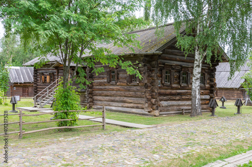 view of the old wooden houses in the park of Russian art in Kostroma, photo was taken on a cloudy summer day