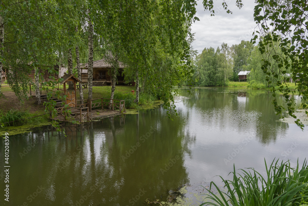 Obraz premium view of the old wooden houses in the park of Russian art in Kostroma, photo was taken on a cloudy summer day