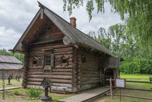 view of the old wooden houses in the park of Russian art in Kostroma, photo was taken on a cloudy summer day © ILIA