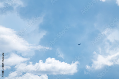 Wallpaper Mural Airplane flying in the blue sky among clouds and sunlight Torontodigital.ca