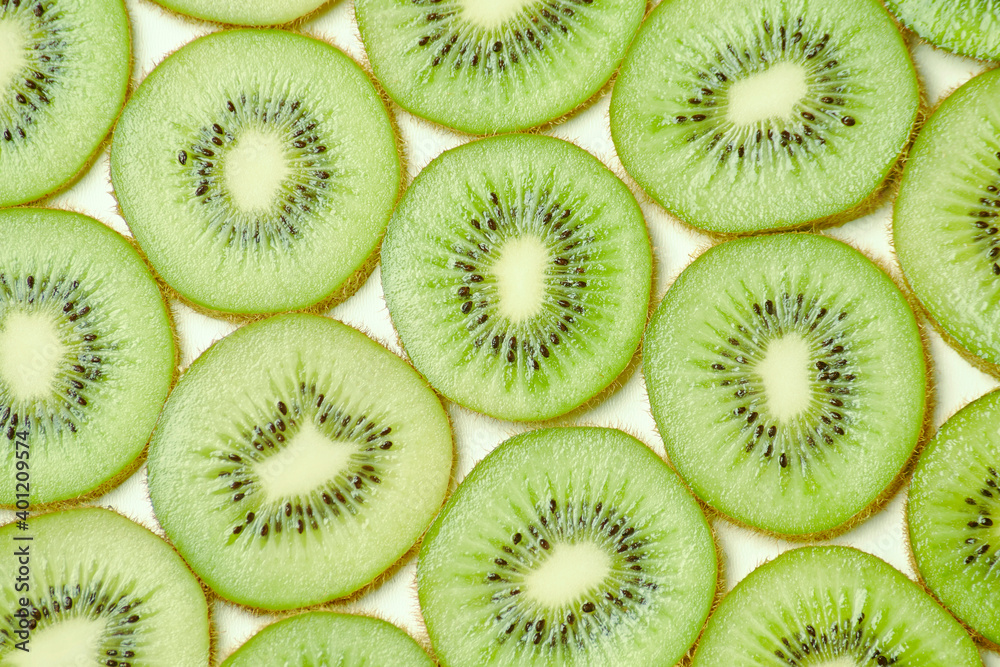 Fototapeta premium Clean fresh half cuted slices of green kiwi fruit rings stack pattern background