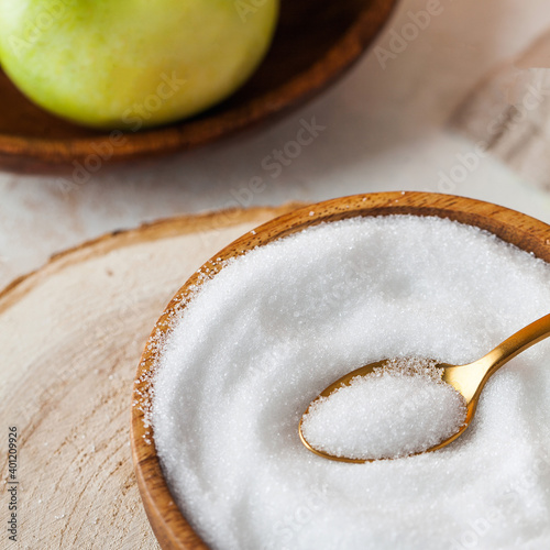 Natural sweetener in a wooden bowl. Erythritol