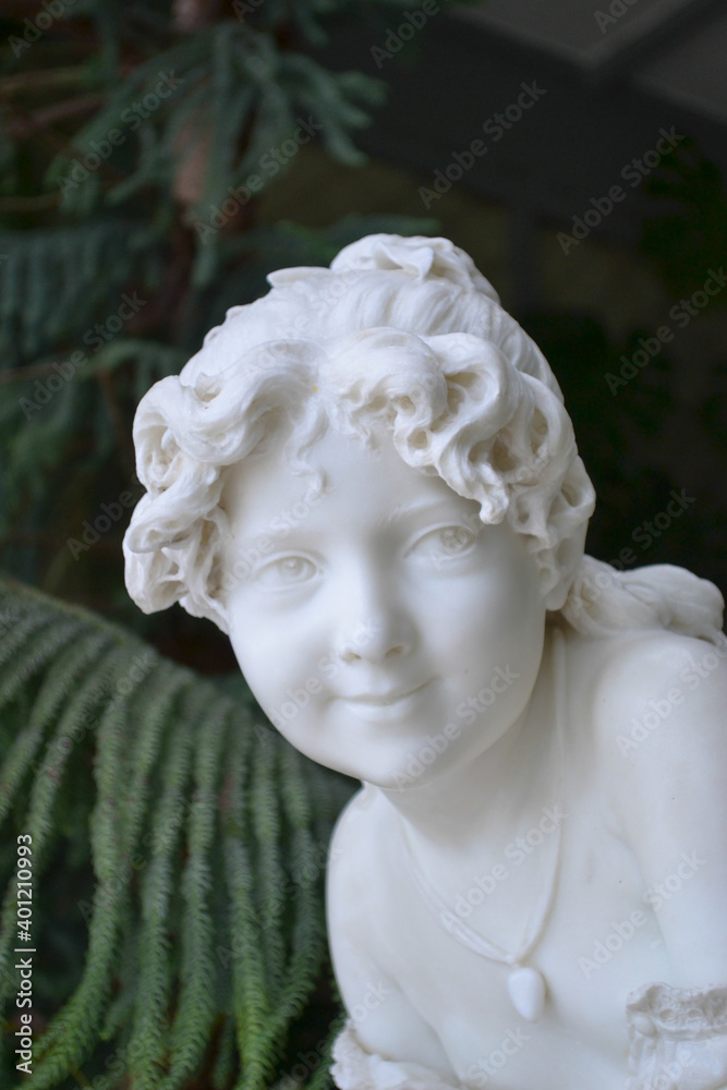 statue of a child in a garden