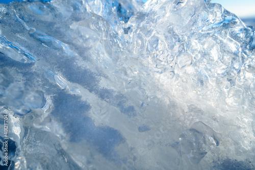 Ice on the snowy surface of an icy river, winter background