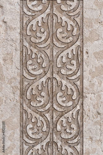 Ornamental print on the granite surface. Vintage ornament on the stone. Embossed drawing. Close-up. Stone texture. Pattern on the stone. Embossed pattern. Wallpaper. Tile. Close-up of seamless texture