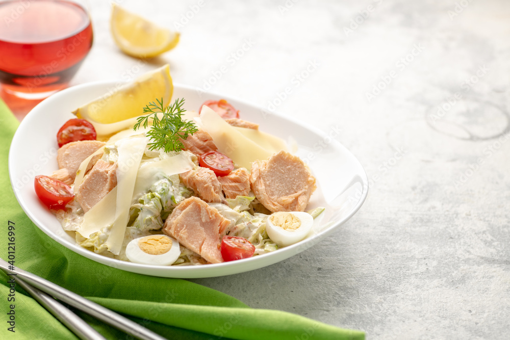 Salad with baked salmon. A large portion of salad with red fish, fresh vegetables, eggs, cherry tomatoes and lemon. Salad with baked salmon. A large portion of salad with red fish, fresh vegetables, eggs, cherry tomatoes and lemon.