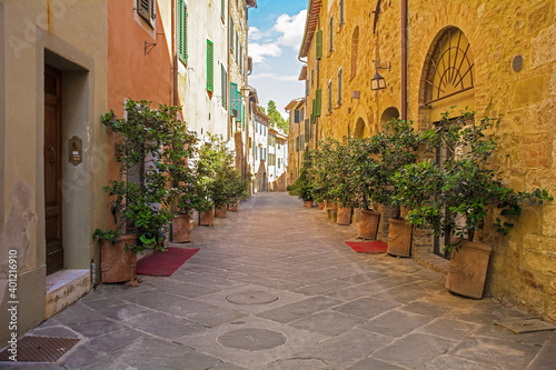 Fototapeta Naklejka Na Ścianę i Meble -  A residential road in the historic medieval village of San Quirico D'Orcia, Siena Province, Tuscany, Italy
