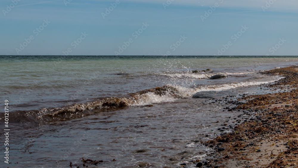 Fototapeta premium Waves and stones at a lovely beach in Denmark