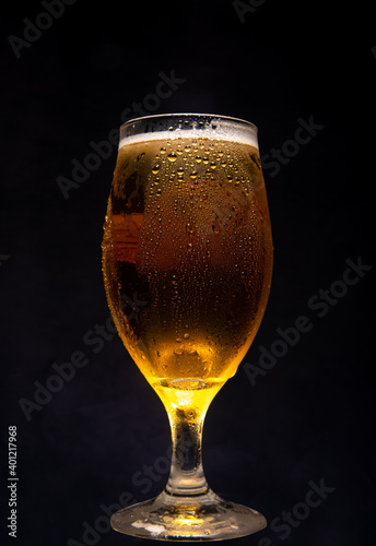 Beer, glass of cold beer with dark background, selective focus.
