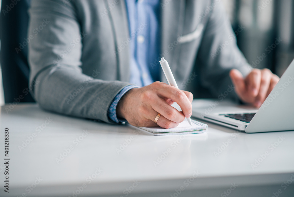 Taking notes in business office, close-up, copy space. Taking notes in business office, close-up, copy space.