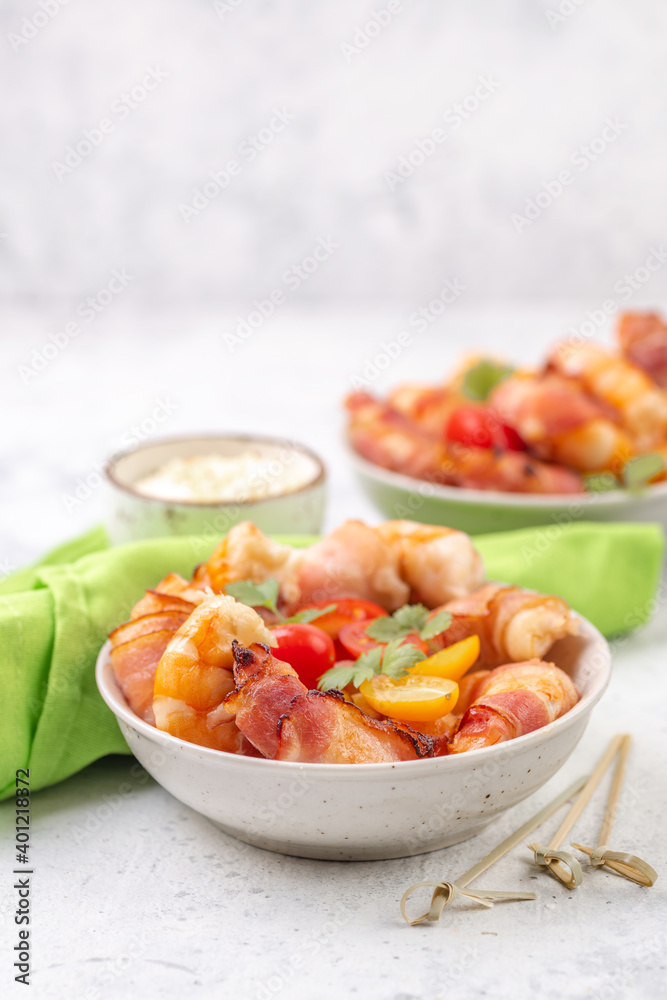 Fried large prawns without shell wrapped in bacon with fresh vegetables and creamy sauce. Fried large prawns without shell wrapped in bacon with fresh vegetables and creamy sauce.