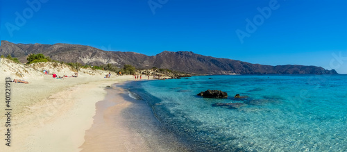 A view across the sandy beach at Elafonissi, Crete on a bright sunny day