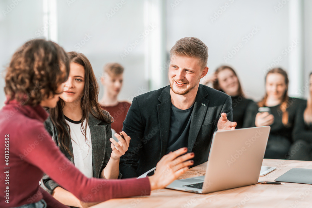 young employees discussing work issues in the workplace