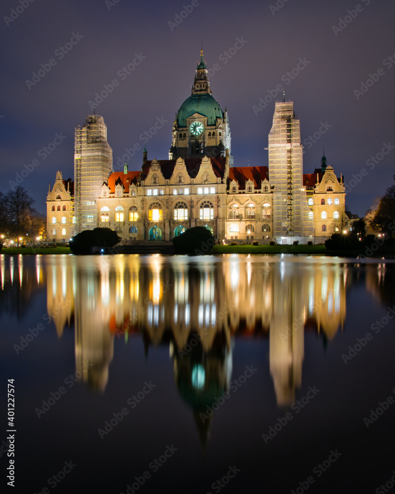 New Town Hall (Neues Rathaus) with a reflection of the building in the lake taken at night with a long exposure, Hanover, Lower Saxony, Germany 