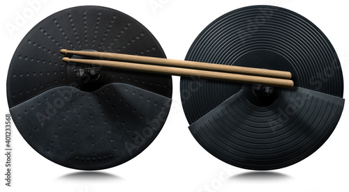 Two black cymbals of an electronic drum kit and a pair of wooden drumsticks, isolated on white background with reflections. Percussion instrument concept.