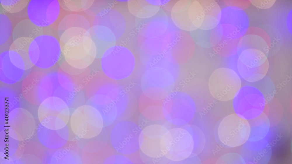 Abstract background for the new year with lilac light. Close up of defocused Christmas lights. Colored lights flicker. There is copy space. Decoration for holiday, party, birthday, wedding.