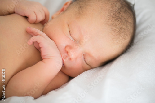 close up. a newborn sleeps in a white crib. concept of healthy children's sleep