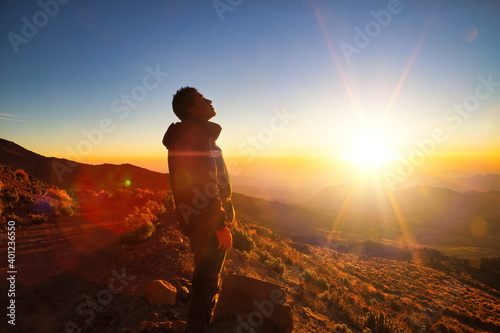 A beautiful shot of sunrise a male standing in sierra negra Volcano in Mexico