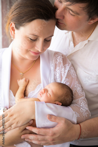 parents with a newborn in arms. a man and a woman with a long-awaited child