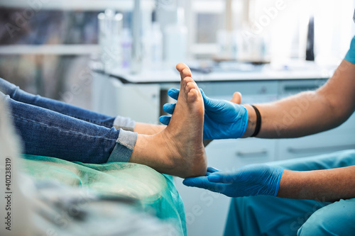 Elegant woman receiving foot treatment in the medical center photo