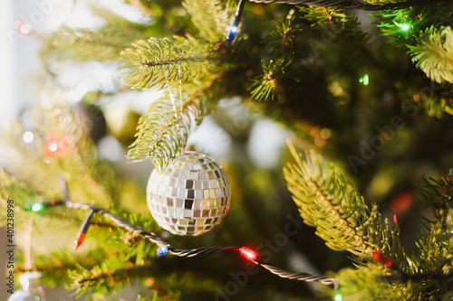 Christmas ball on a Christmas tree with a garland on the background. New Year background