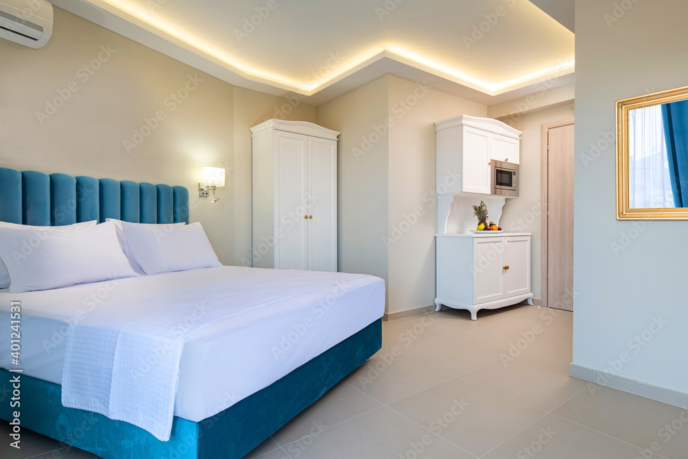 Classic style interior of white and blue bedroom with kitchen cupboard module cabinet in double suite hotel apartment flat Classic style interior of white and blue bedroom with kitchen cupboard module cabinet in double suite hotel apartment flat