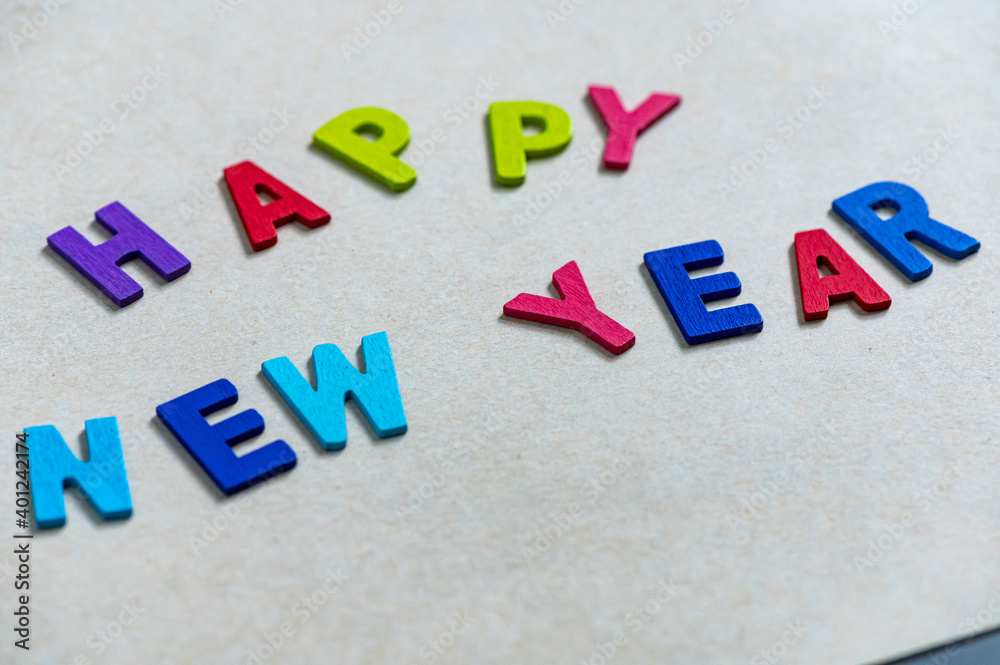 Obraz premium Happy new year font art colorful texting for greeting or celebrate card with light brown background, Sensitive Focus