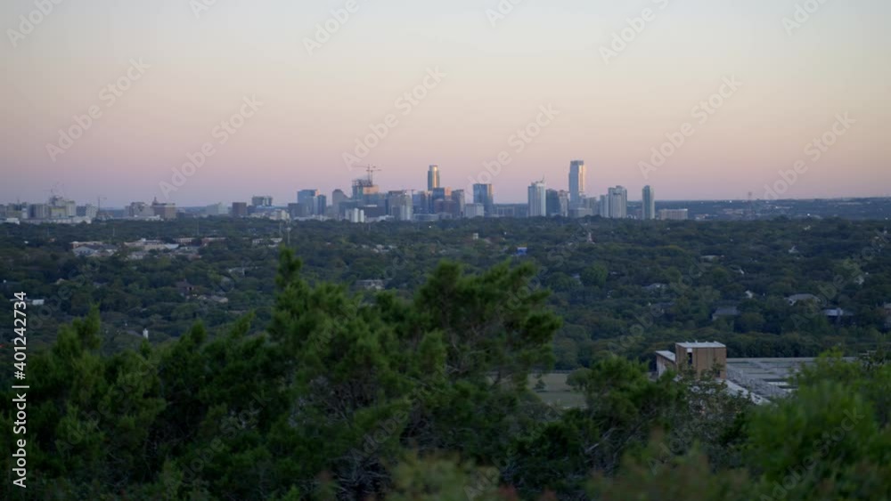 Handheld 4k slow motion establishing shot of the cityscape and buildings of Austin, Texas from public park in the warm, south American state Handheld 4k slow motion establishing shot of the cityscape and buildings of Austin, Texas from public park in the warm, south American state