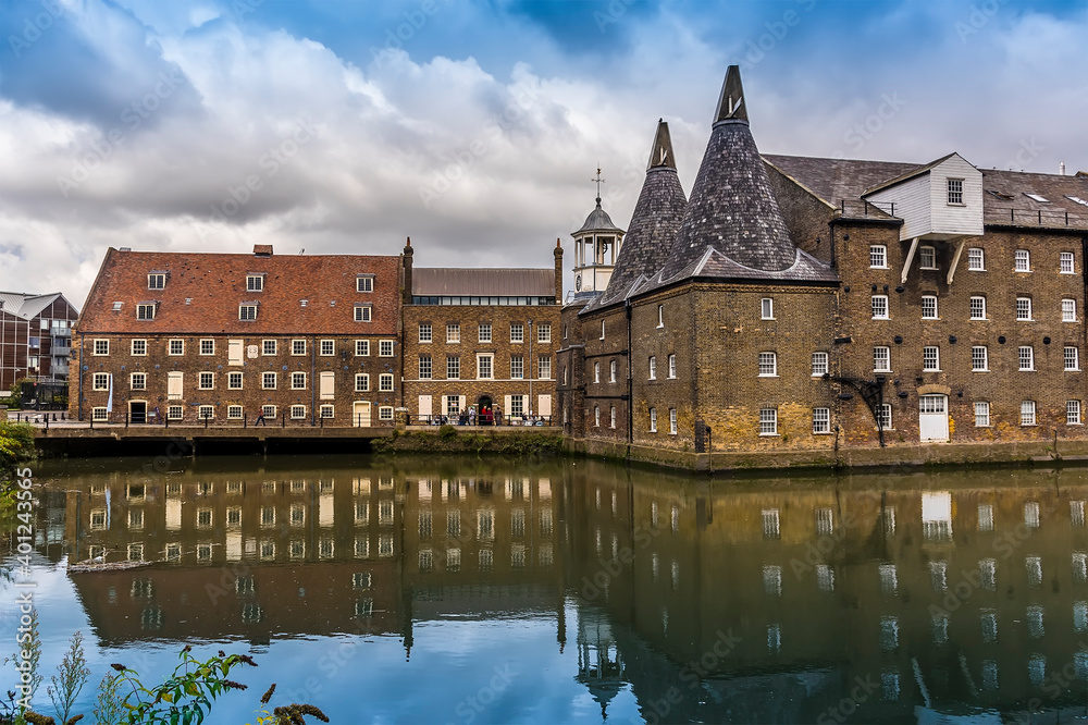 A view across the Channelsea River towards the Three Mills, part of the oldest tidal mills complex in the world in Lee Valley, London in the summertime