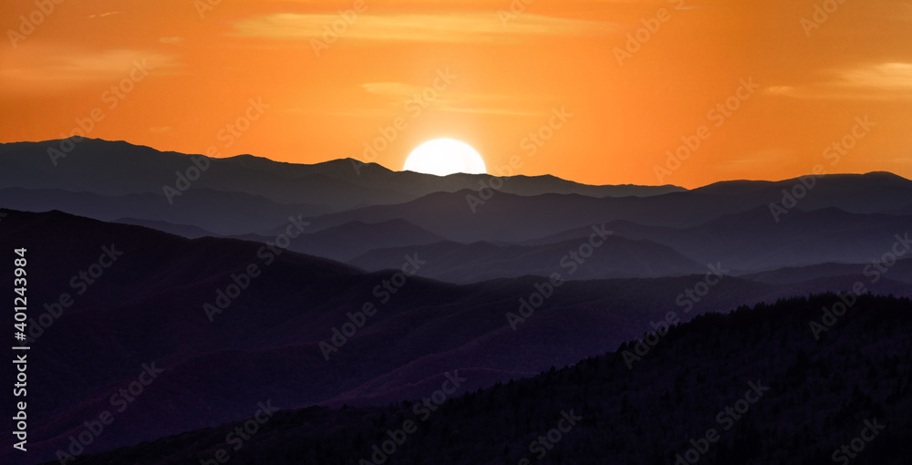 Sunset over the smoky mountains wil rolling hills