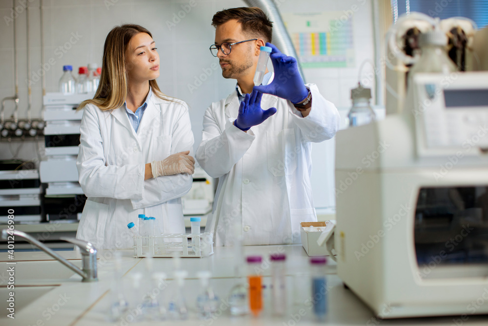 Group of young researchers analyzing chemical data in the laboratory Group of young researchers analyzing chemical data in the laboratory
