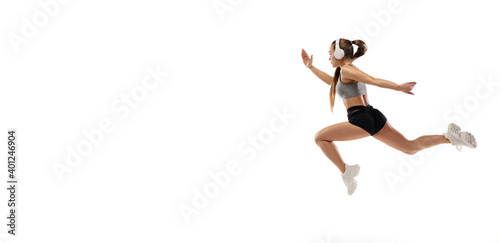 Flyer. Caucasian professional female athlete, runner training isolated on white studio background. Muscular, sportive woman. Concept of action, motion, youth, healthy lifestyle. Copyspace for ad.