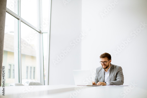 Young man working on laptop...