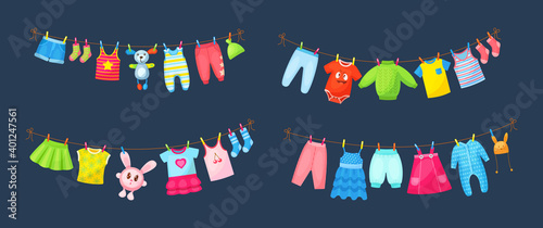 Baby clothes hanging on clothesline. Drying children's clothes and accessories after washing on rope. Shorts, socks, romper, sweater, hat, toys, T-shirt, sarafans, dress, skirts, blouse cartoon
