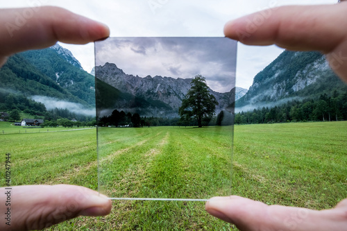 Fotografi Professional photographer holding ND Gradient Filter glass appreciating an effect