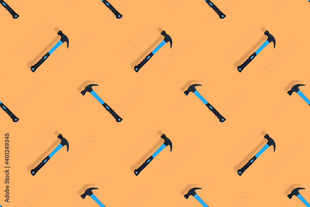 Hammer on an orange background. Hammer seamless pattern. Hammer on an orange background. Hammer seamless pattern.