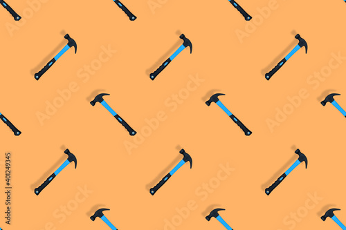 Hammer on an orange background. Hammer seamless pattern.