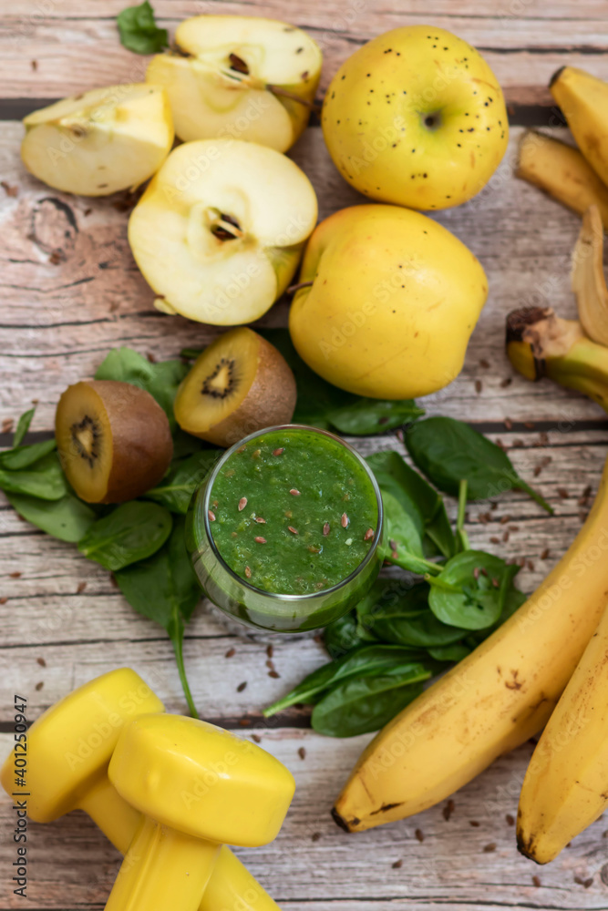 A glass of kiwi, spinach and apple smoothie. Health drink. Apples, flax seeds, spinach, kiwi, bananas lie nearby.
A glass of kiwi, spinach and apple smoothie. Health drink. Apples, flax seeds, spinach, kiwi, bananas lie nearby.