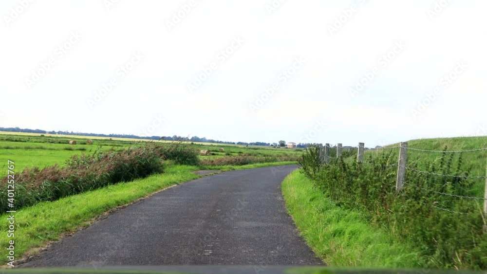 driving at country road, dike road, north Germany, idyllic
