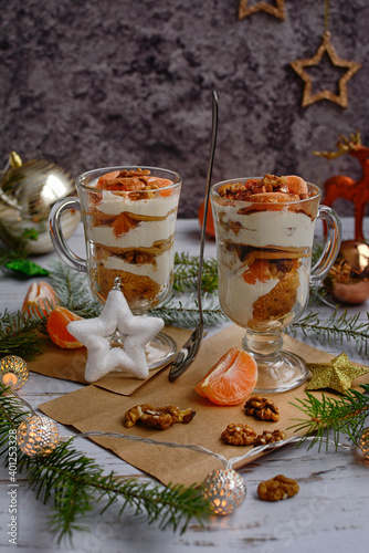 Vertical New Year composition. Light curd dessert in glasses on a wooden background.