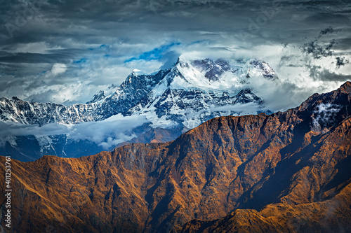 Snow covered mountain peak Chaukamba in clouds - the Himalayas, Uttarakhand, India. View from Chandrashila mountain. Shot on the special date of 11.11.11