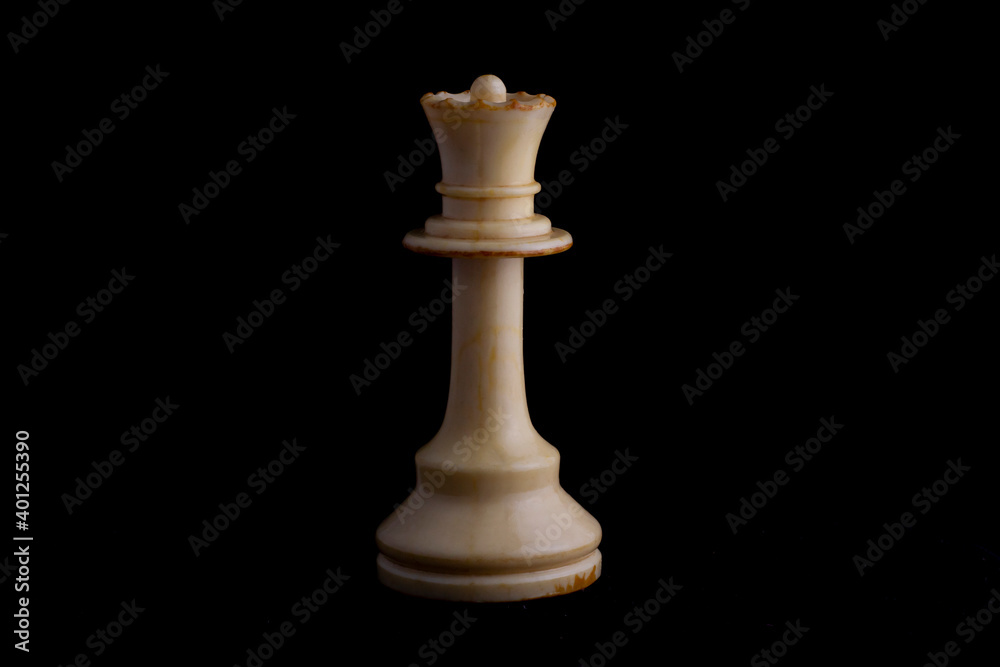 one side light on white queen chess piece in black background one side light on white queen chess piece in black background