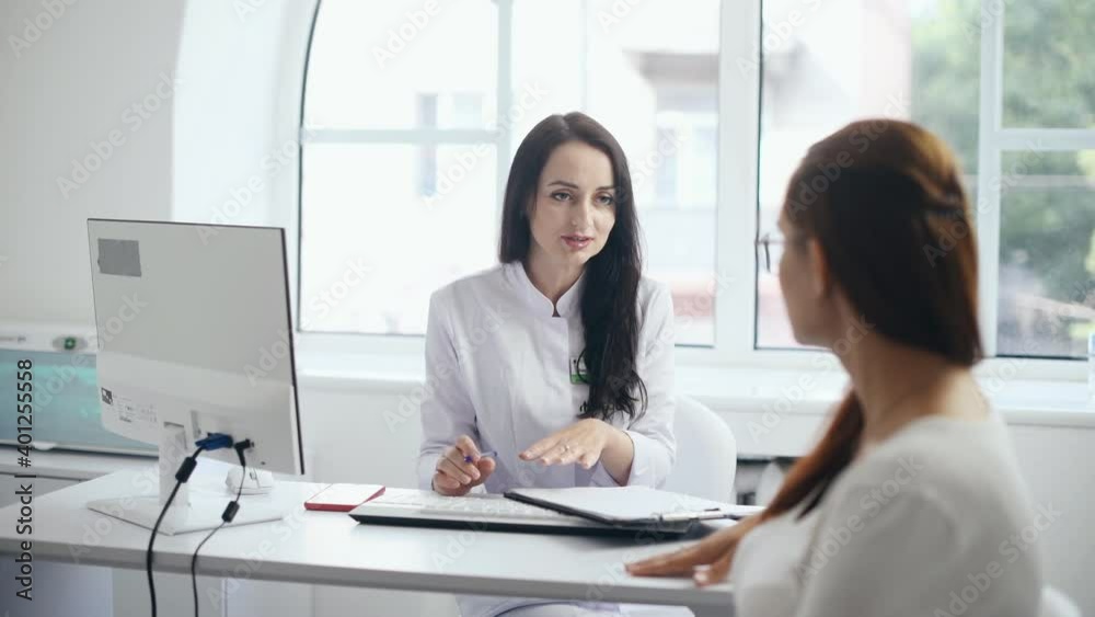 Pregnant woman have consultation with obstetrician indoors. Pregnant woman have consultation with obstetrician indoors.